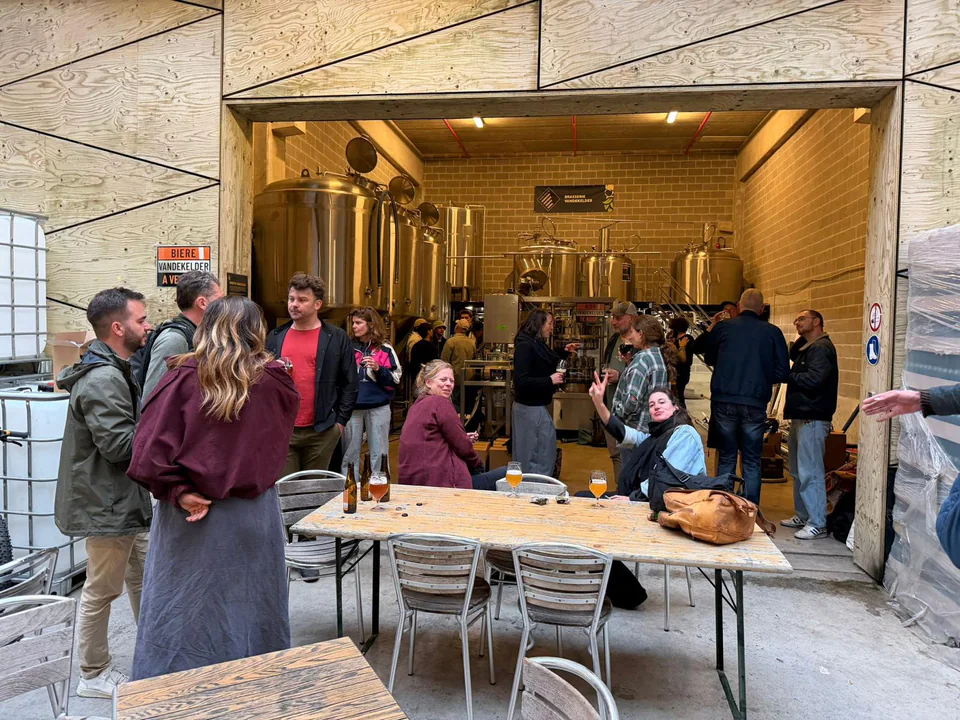 People sharing beers together in the Vandekelder brewery space
